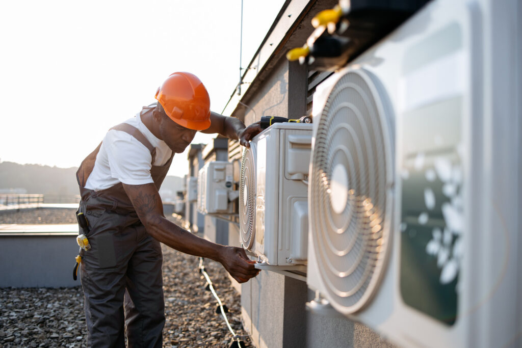 african man in uniform checking air conditioner on 2023 12 21 22 00 43 utc 1